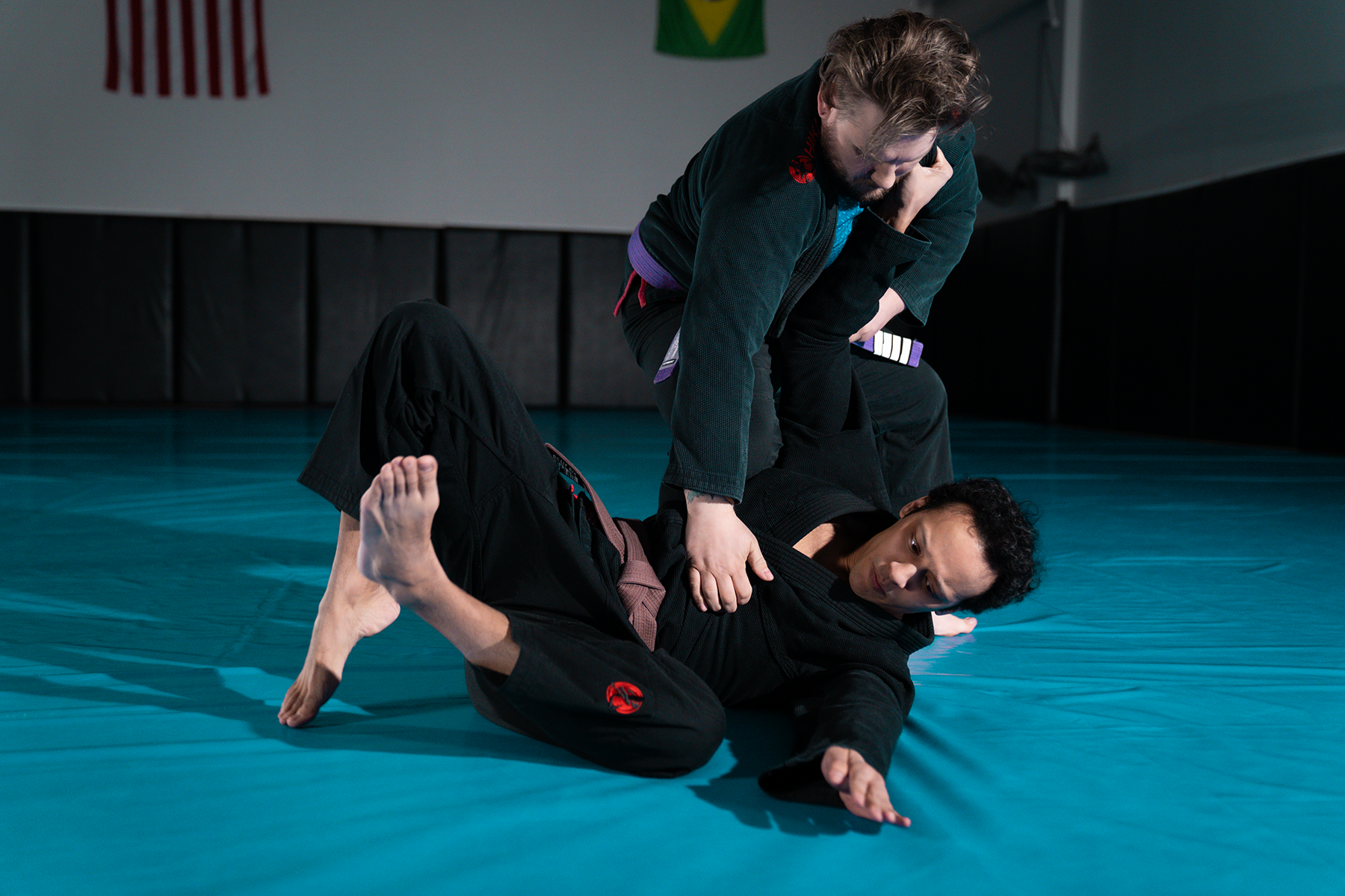 Two Brazilian jiu-jitsu practitioners training in black Hikari gis